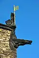 Gargoyle and the lion with the flag of England from the royal arms