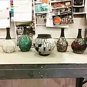 Raku work with crackle glazes (left) copper glazes (right) and pop-off slip (center)