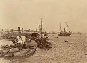 Image 13The paddle steamer Ramapoora (right) of the British India Steam Navigation Company on the Rangoon river having just arrived from Moulmein. 1895. Photographers: Watts and Skeen (from History of Myanmar)