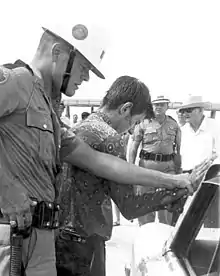 Black and white photograph of a segregationist arrested