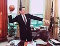 President Ronald Reagan with a football in the Oval Office