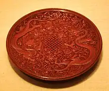 Ming dynasty red lacquerware dish with Chinese dragons and an endless knot