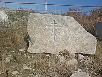 One of many religious symbols carved into stone sitting on the side of the pathway up to the mask of sorrow. This is an Eastern Orthodox cross