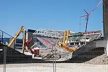 final hours of the main stand with the new stadium rising behind (July 2013)