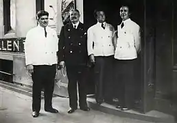 Doorman B. Stålkrantz and three waiters, ca. 1940. Photographer unknown. Photo owned by the Oslo Museum.