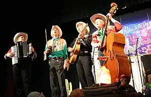 Riders in the Sky appearing at the Ponca Theatre in Ponca City, Oklahoma on September 29, 2007 at a concert commemorating the 100th anniversary of the birth of Gene Autry. From left to right are Joey the Cow Polka King, Woody Paul, Ranger Doug and Too Slim.