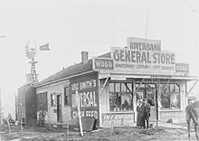 Black-and-white photograph of the Riverbank general store, with "Yolo County Free Library" among other signage.