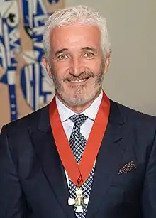 portrait photo of a man wearing a medal