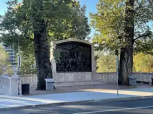 A photo of the of the Robert Gould Shaw Memorial taken after the completed renovations in 2021. The photo depicts the sculpture set further back from the street to allow for more standing room and benches.