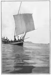 Roller-reefing the sail of a perahu payang.