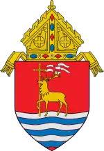 The arms of the Archdiocese of Hartford: The arms feature a hart, a male deer, in the midst of flowing water, i.e., fording a body of water, referencing the name of the see, Hartford, Connecticut.