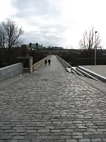 Photo of a bridge with a surface of flat stones