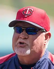 A man in a navy jacket and red cap