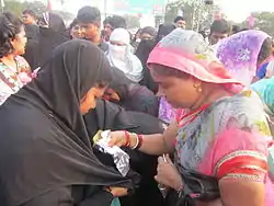 Hindu-Muslim women Pilgrims exchanging Rotis,at svarana Tank,Nellore