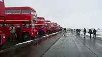 In mid-winter, a line of AEC Routemasters at a Cobham Bus Museum rally on the runway at a snowy Wisley Airfield.