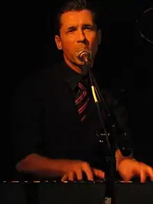 Royal Wood seen playing keyboards and singing into a microphone