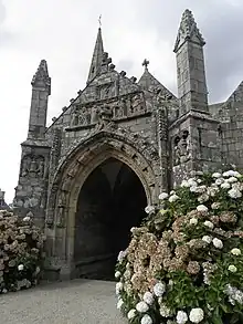 Photograph of a church porch in granite, carved in bas-relief