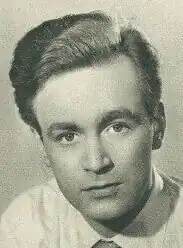 An 87-year-old man with white hair and glasses looking to the right of the camera