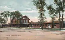 A postcard view of a large railway station