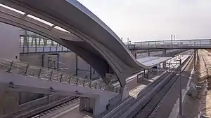 Curved metal roof leading down to island platform