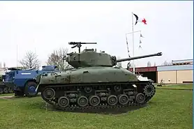 A M4 Sherman tank profile view and a VXB-170 Berliet partially hidden by the tank.