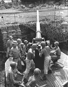 No. 2 Gun Crew, Btry D, 208th CA AA, man their 3-inch AA gun at New Fighter Strip, Dobodura, New Guinea (17 May 1943).