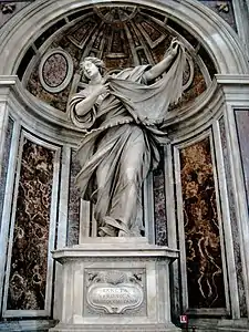  This statue shows the saint as a young woman, who, with a sweeping dramatic gesture, displays a cloth on which there is an image of the face of Jesus.