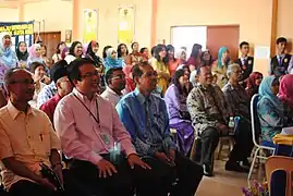 Mr. Kuan Chee Kheong, teachers and VIPs watching a video about the 10th Year Anniversary of SMK Kota Kemuning.