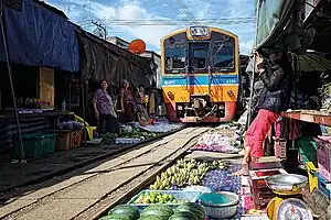 A train passing through the Maeklong Railway Market in 2015