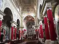 The interior of the church covered in red during the patronal feast.