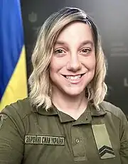 Ashton-Cirillo, in uniform, Ukrainian flag in background