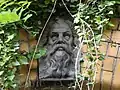 Stone face keystone on the arched doorway of a building circa 1930