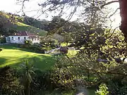 Park view with historic Scandrett homestead & farm buildings.