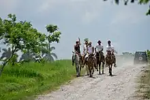 Photo of a group of white riders, seen from the front.