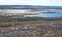 A village on a lake surrounded by barren land