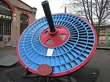 Blue disc-shaped turbine wheel with three blade rings.