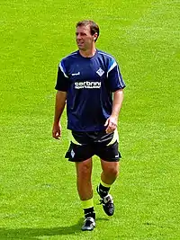 A man, wearing a sports training kit