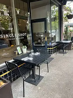 Photograph of the exterior of a restaurant with outdoor seating