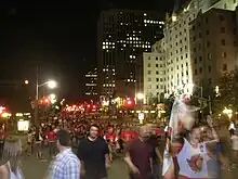 group of people outdoors at night on a city street