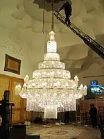 Large modern chandelier being worked on, Iran.