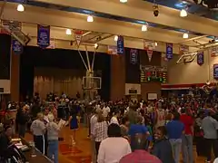 A crowd gathers on the basketball court at Sharp Gymnasium after a men's basketball game between the Houston Baptist Huskies and Bacone Warriors on February 9, 2008.