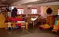 A photograph of the Kindergarten room at Shearwater. The primary school rooms are rather irregular, each designed specifically for those children; note that the desks are in a cross.