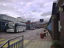 The central area of Sheffield Interchange. Visible are National Express, First South Yorkshire and Stagecoach services.Also visible is the Archway centre (the main block of the interchange) and the Odeon cinema (left)