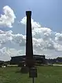 The remaining smoke stack from the machine shop.