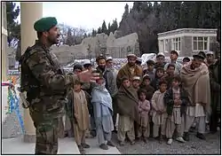 An Afghan Army captain talks to Sherzad villagers