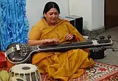 The tambura or tanpura may have a toomba (although not in this picture), a resonator made of calabash at the end of the strings table.