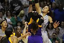 Two women straining up at a jump ball