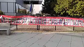 Banner with photographs depicting the missing from the conflict