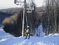 Ski lifts and slopes covered with natural snow.