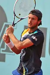 João Sousa hitting a two-handed backhand during a match